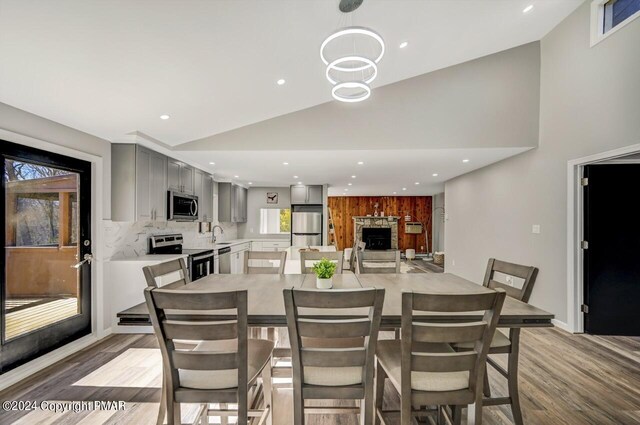 181 Williams Ln, Scotrun, PA 18355 - dining area featuring light wood-style floors, recessed lighting, a fireplace, and high vaulted ceiling
