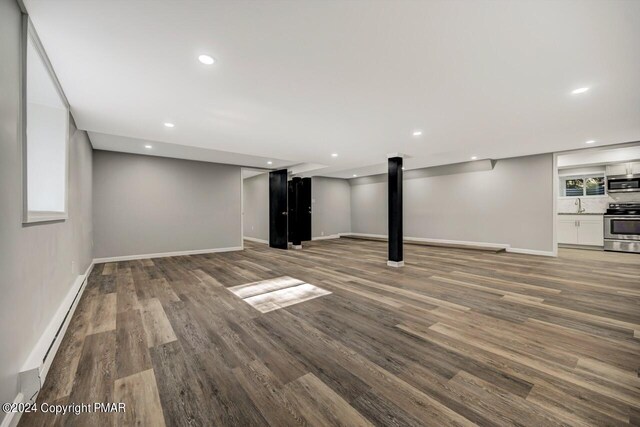 181 Williams Ln, Scotrun, PA 18355 - basement featuring a baseboard heating unit, wood finished floors, baseboards, a sink, and recessed lighting