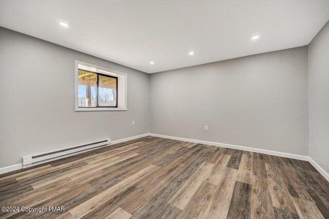 181 Williams Ln, Scotrun, PA 18355 - empty room with baseboard heating, wood finished floors, baseboards, and recessed lighting