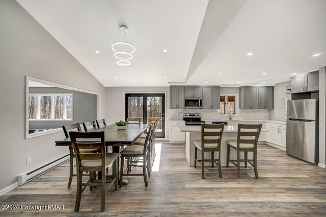 181 Williams Ln, Scotrun, PA 18355 - dining room with baseboard heating, light wood finished floors, recessed lighting, a chandelier, and vaulted ceiling