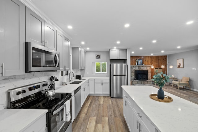 181 Williams Ln, Scotrun, PA 18355 - kitchen featuring appliances with stainless steel finishes, recessed lighting, tasteful backsplash, light wood-type flooring, and light stone counters