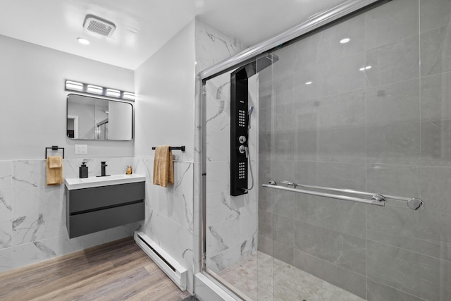 181 Williams Ln, Scotrun, PA 18355 - full bathroom with a baseboard heating unit, tile walls, vanity, a marble finish shower, and wainscoting