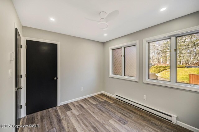 181 Williams Ln, Scotrun, PA 18355 - unfurnished room with baseboard heating, wood finished floors, baseboards, and recessed lighting