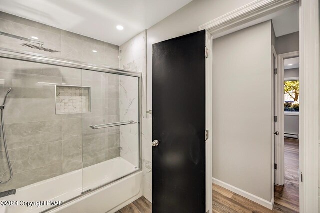 181 Williams Ln, Scotrun, PA 18355 - bathroom featuring wood finished floors, a baseboard heating unit, enclosed tub / shower combo, baseboards, and recessed lighting