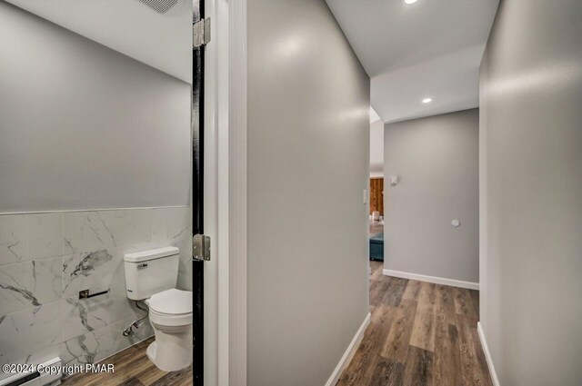 181 Williams Ln, Scotrun, PA 18355 - corridor featuring wood finished floors, tile walls, recessed lighting, a baseboard radiator, and wainscoting