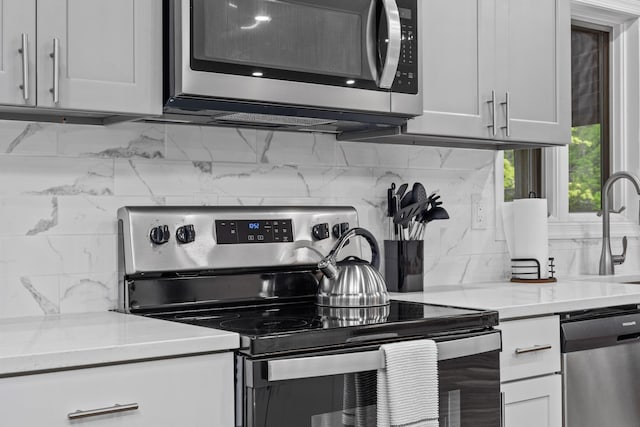 181 Williams Ln, Scotrun, PA 18355 - kitchen featuring appliances with stainless steel finishes, tasteful backsplash, and white cabinets