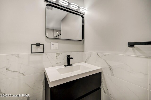 181 Williams Ln, Scotrun, PA 18355 - bathroom featuring tile walls, vanity, and a wainscoted wall