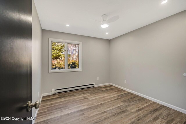181 Williams Ln, Scotrun, PA 18355 - unfurnished room with a baseboard radiator, a ceiling fan, wood finished floors, baseboards, and recessed lighting