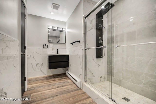 181 Williams Ln, Scotrun, PA 18355 - full bathroom with a baseboard radiator, a shower stall, wood finished floors, tile walls, and vanity