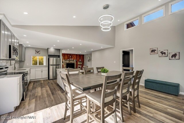 181 Williams Ln, Scotrun, PA 18355 - dining space featuring wood finished floors, a fireplace, recessed lighting, and a high ceiling