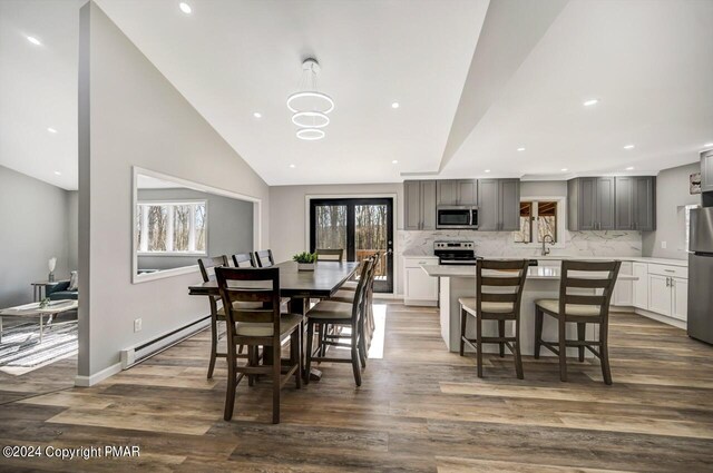 181 Williams Ln, Scotrun, PA 18355 - dining room with a baseboard heating unit, plenty of natural light, dark wood finished floors, recessed lighting, and lofted ceiling