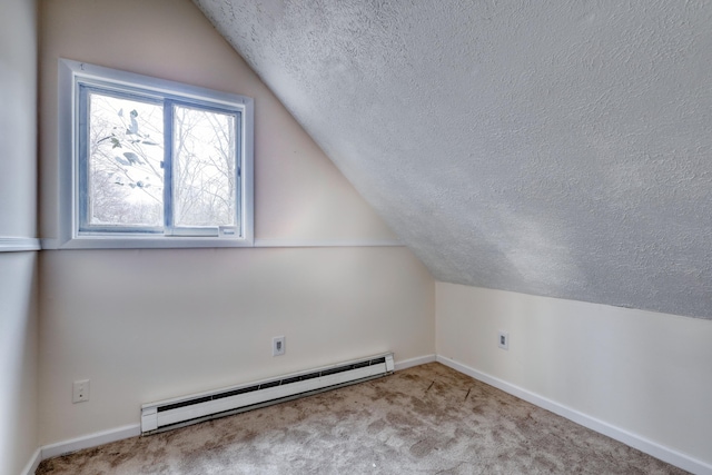 1452 Waterfront Dr, Tobyhanna, PA 18466 - bonus room featuring a baseboard radiator, a textured ceiling, vaulted ceiling, baseboards, and carpet floors