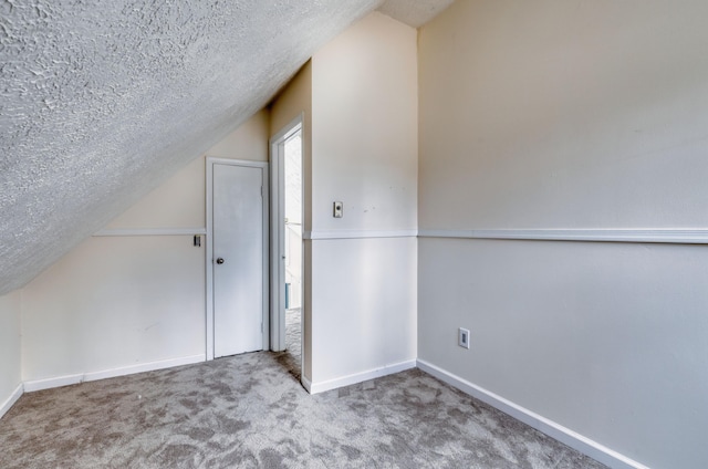 1452 Waterfront Dr, Tobyhanna, PA 18466 - additional living space featuring a textured ceiling, vaulted ceiling, carpet floors, and baseboards