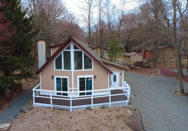 1452 Waterfront Dr, Tobyhanna, PA 18466 - back of house with a chimney and a wooden deck
