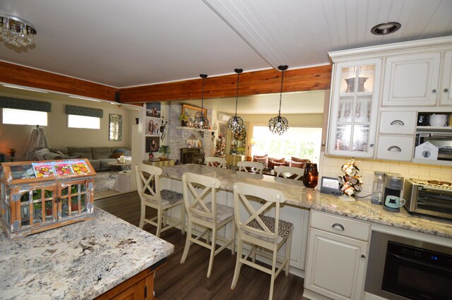 1618 Kickapoo Ter, Effort, PA 18330 - kitchen featuring dark wood-type flooring, a peninsula, white cabinets, and glass insert cabinets