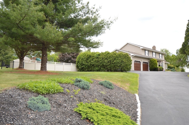 1618 Kickapoo Ter, Effort, PA 18330 - view of front of home featuring a chimney, asphalt driveway, and an attached garage