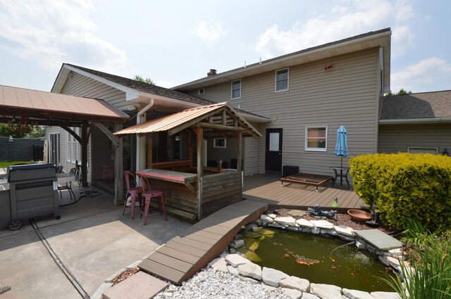 1618 Kickapoo Ter, Effort, PA 18330 - rear view of house with a gazebo, a wooden deck, a patio area, and a garden pond