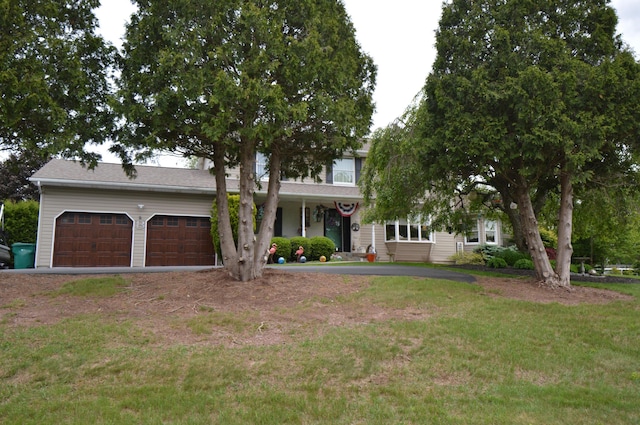 1618 Kickapoo Ter, Effort, PA 18330 - view of front facade with a front yard, an attached garage, driveway, and covered porch
