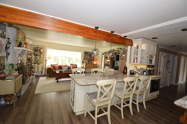 1618 Kickapoo Ter, Effort, PA 18330 - kitchen with dark wood-type flooring, a kitchen breakfast bar, light stone counters, hanging light fixtures, and glass insert cabinets