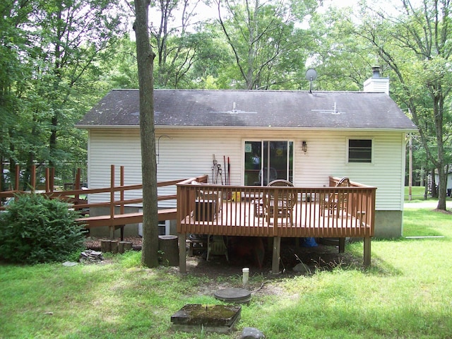 139 Davis Cir, Bushkill, PA 18324 - back of house with a wooden deck, a chimney, a yard, and a shingled roof