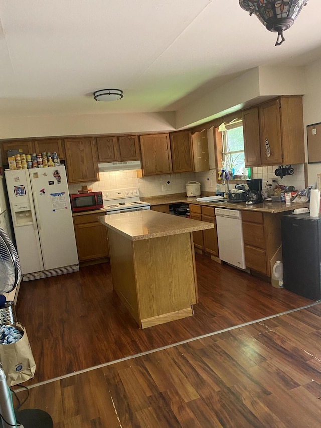 139 Davis Cir, Bushkill, PA 18324 - kitchen featuring white appliances, under cabinet range hood, a center island, dark wood-style flooring, and decorative backsplash