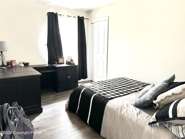 bedroom with light wood-type flooring and a closet