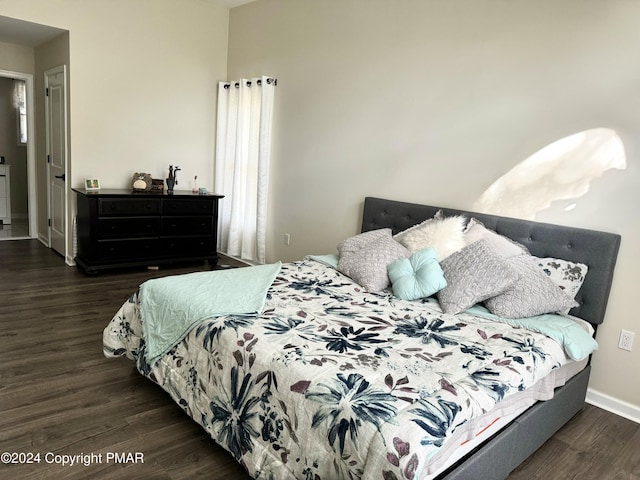 bedroom featuring baseboards and wood finished floors