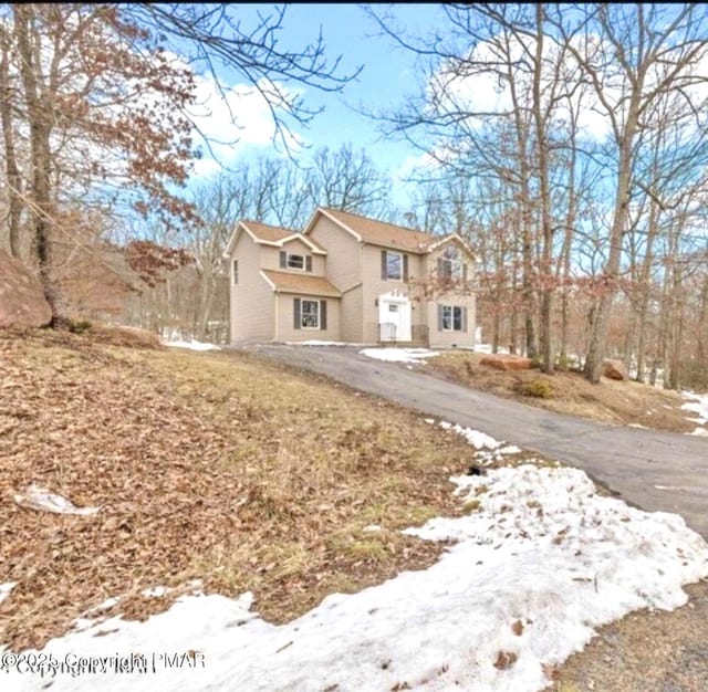 traditional home with aphalt driveway