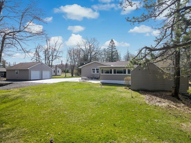 148 Summit Ave, Pocono Summit, PA 18346 - back of property featuring an outdoor structure, a detached garage, a lawn, and a chimney