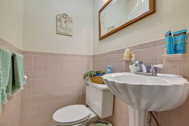 148 Summit Ave, Pocono Summit, PA 18346 - half bathroom with tile walls, wainscoting, toilet, and a sink