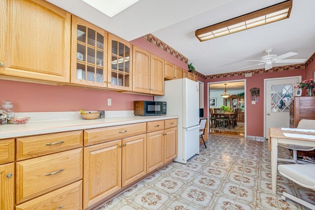 148 Summit Ave, Pocono Summit, PA 18346 - kitchen with glass insert cabinets, black microwave, light countertops, light floors, and a ceiling fan