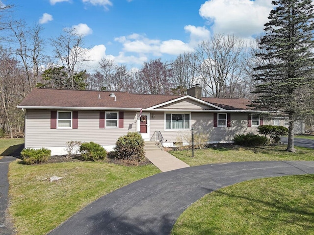 148 Summit Ave, Pocono Summit, PA 18346 - single story home with a chimney, a shingled roof, and a front lawn