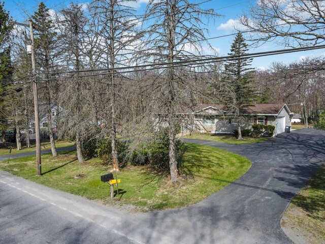 148 Summit Ave, Pocono Summit, PA 18346 - view of front of property featuring a front lawn, an attached garage, and aphalt driveway