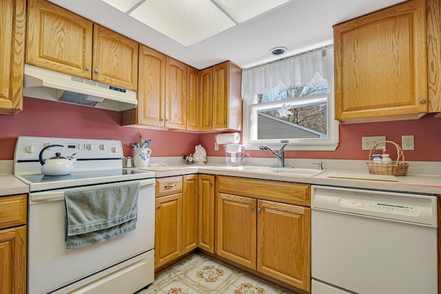 148 Summit Ave, Pocono Summit, PA 18346 - kitchen with white appliances, brown cabinetry, under cabinet range hood, light countertops, and a sink
