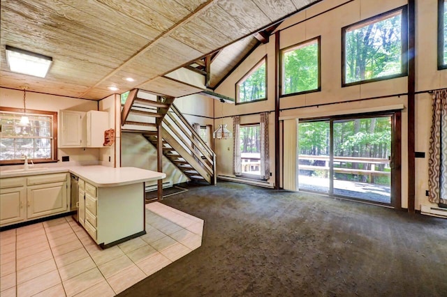 13 Sheffick Rd, Clifton Township, PA 18424 - kitchen featuring wooden ceiling, light countertops, high vaulted ceiling, a peninsula, and decorative light fixtures