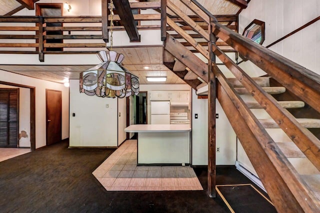 13 Sheffick Rd, Clifton Township, PA 18424 - kitchen featuring white appliances, a peninsula, white cabinetry, beam ceiling, and carpet floors