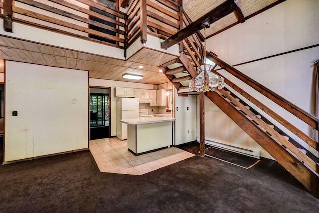 13 Sheffick Rd, Clifton Township, PA 18424 - kitchen with a baseboard heating unit, white appliances, a peninsula, light countertops, and carpet flooring