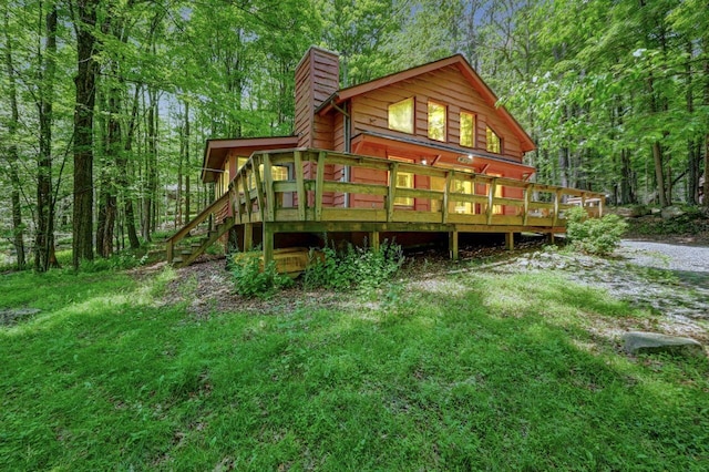 13 Sheffick Rd, Clifton Township, PA 18424 - back of house featuring a chimney, stairs, a wooden deck, and a forest view