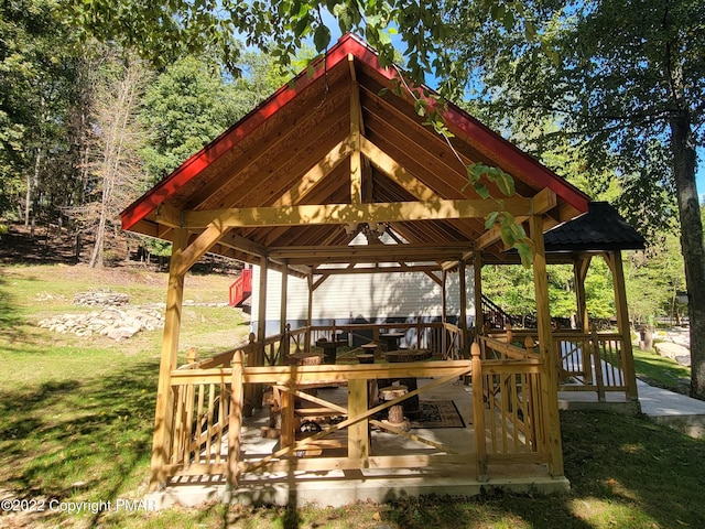 view of home's community featuring a gazebo, a wooden deck, and a lawn