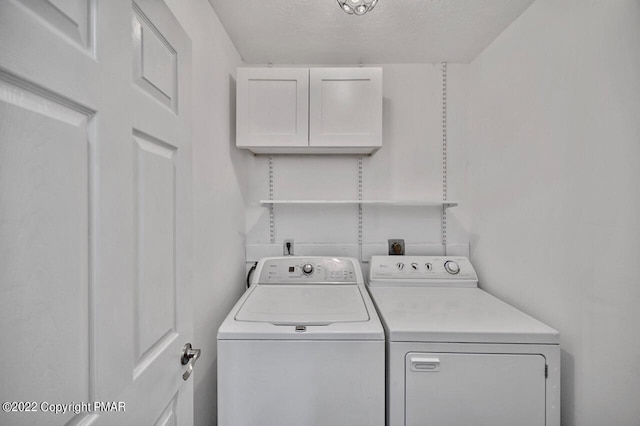 laundry area with cabinet space and washing machine and clothes dryer
