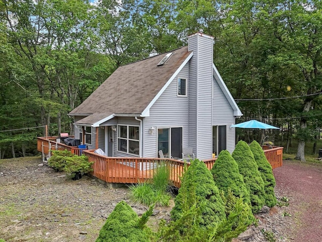 2218 Lancaster Dr, Lehman, PA 18324 - rear view of property with a shingled roof, a wooden deck, and a chimney