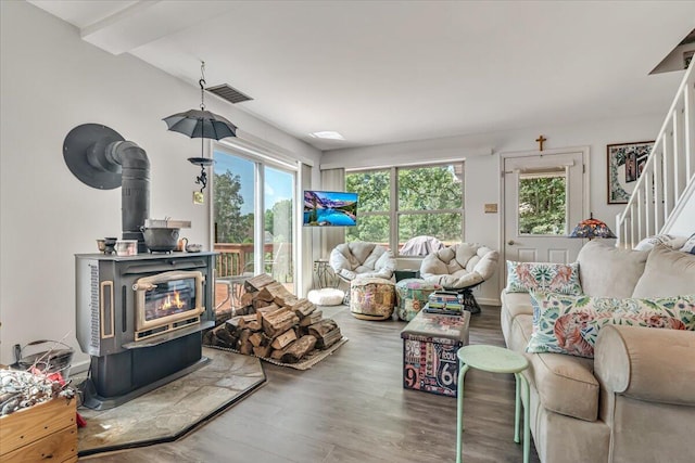 2218 Lancaster Dr, Lehman, PA 18324 - living area with a wood stove, wood finished floors, and stairs