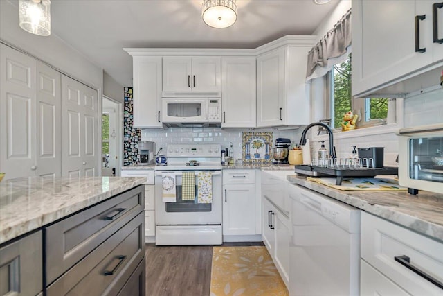 2218 Lancaster Dr, Lehman, PA 18324 - kitchen with white appliances, backsplash, white cabinetry, and light stone countertops