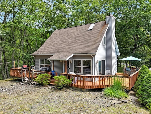 2218 Lancaster Dr, Lehman, PA 18324 - back of house with a chimney, a shingled roof, and a wooden deck
