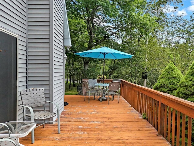 2218 Lancaster Dr, Lehman, PA 18324 - wooden deck featuring outdoor dining space and view of wooded area