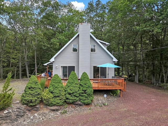 2218 Lancaster Dr, Lehman, PA 18324 - rear view of property with a wooden deck, a chimney, and a wooded view