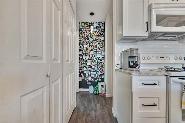 2218 Lancaster Dr, Lehman, PA 18324 - kitchen featuring white appliances, dark wood-style floors, white cabinetry, hanging light fixtures, and light stone counters
