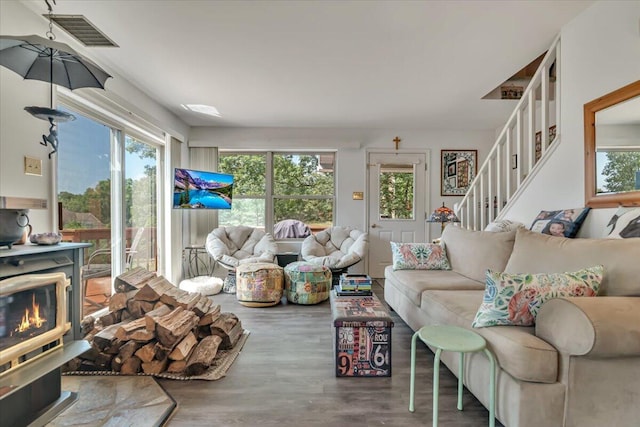 2218 Lancaster Dr, Lehman, PA 18324 - living room with wood finished floors, stairway, and a wood stove