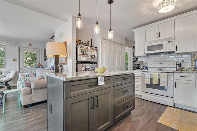 2218 Lancaster Dr, Lehman, PA 18324 - kitchen featuring white appliances, open floor plan, wood finished floors, white cabinetry, and decorative backsplash