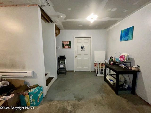 interior space with concrete flooring and baseboard heating